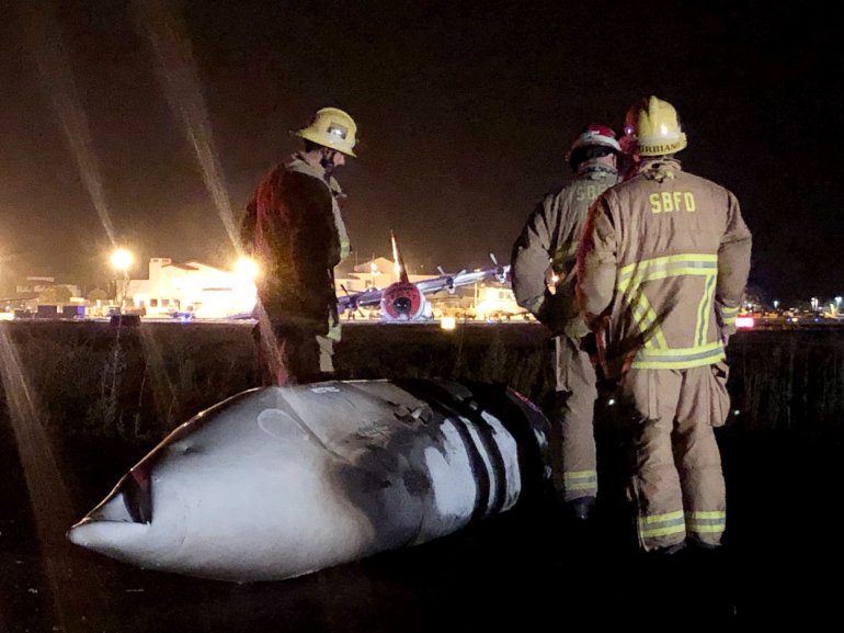 Seven people escaped unharmed after a C-130 airplane made an emergency landing and caught fire at Santa Barbara Airport on Aug. 25, 2019. (Credit: Santa Barbara County Fire Department)