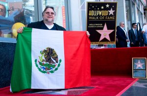 Director Guillermo Del Toro poses with the Mexican flag during the ceremony for his Star on the Hollywood Walk of Fame on Aug. 6, 2019. (Credit: Valerie Macon/AFP/Getty Images)