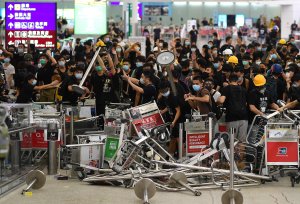Pro-democracy protestors block the entrance to the airport terminals after a scuffle with police at Hong Kong's international airport late on Aug. 13, 2019. (Credit: MANAN VATSYAYANA/AFP/Getty Images)