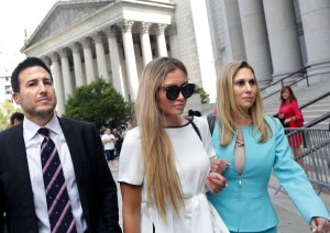 Jennifer Araoz, center, one of deceased financier Jeffrey Epstein's alleged victims, and her attorney Kimberly Lerner, right, finish speaking to the press outside federal court in New York City on Aug. 27, 2019. (Credit: Yana Paskova / AFP / Getty Images)