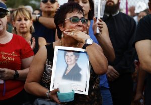 Lupe Lopez carries a photo of Elsa Mendoza Marquez, a Mexican schoolteacher from across the border in Ciudad Juarez who was killed in the shooting, during an interfaith vigil for victims of a mass shooting, which left at least 20 people dead, on August 4, 2019 in El Paso, Texas. (Credit: Mario Tama/Getty Images)