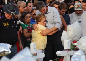 Democratic presidential candidate and former Rep. Beto O’Rourke (D-TX) hugs a woman at a makeshift memorial outside Walmart honoring victims of a mass shooting there which left 22 people dead, on August 7, 2019 in El Paso, Texas. (Credit: Mario Tama/Getty Images)