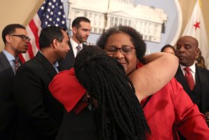 California State Assemblywoman Shirley Weber (D-San Diego) is hugged by Tanya Faison of Black Lives Matter Sacramento during a news conference to announce new legislation to address recent deadly police shootings on April 3, 2018, in Sacramento, California. (Credit: Justin Sullivan/Getty Images)