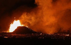 Lava erupts and flows from a Kilauea volcano fissure in Leilani Estates, on Hawaii's Big Island on May 23, 2018. (Credit: Mario Tama/Getty Images)