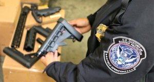 A CBP officer inspects one of the firearms parts seized at the LA/Long Beach Seaport (Credit: U.S. Customs and Border Protection)