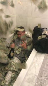 Sitting a tub filled with bills of money, 22-year-old Wyatt Pasekis appears in an undated photo released by the U.S. Department of Justice on Aug. 26, 2019.