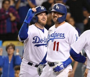 Max Muncy of the Los Angeles Dodgers celebrates with A.J. Pollock during a game against the Colorado Rockies at Dodger Stadium on Sept. 20, 2019. (Credit: John McCoy/Getty Images)