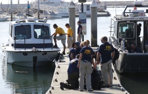FBI personnel gather on a jetty by FBI Dive Team boats in Santa Barbara Harbor on Sept. 4, 2019. (Credit: Mario Tama/Getty Images)