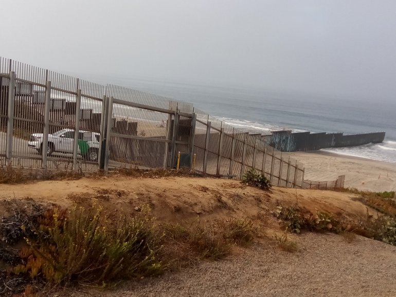 A U.S. Border Patrol vehicle guards a 'security zone' in Imperial Beach, next to the border wall. (Credit: Julian Resendiz)