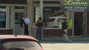 Officials investigate the scene of a jewelry store robbery that led to a fatal police shooting in Glendora on Sept. 6, 2019. (Credit: KTLA) 