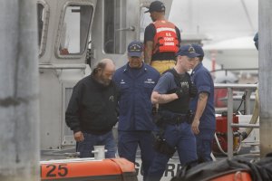 A crew member rescued from a dive boat that burned off Santa Cruz Island is brought back to the U.S. Coast Guard headquarters at Channel Islands Harbor in Oxnard on Sept. 2, 2019. (Credit: Carolyn Cole/Los Angeles Times)