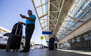 A traveler at Ontario International Airport waits for his Uber in this undated photo. (Credit: Allen J. Schaben/Los Angeles Times)