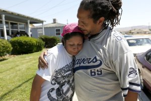 Roberta Alcantar, left, mother of the victim, is comforted by Pharaoh Mitchell, co-founder of the Community Action League, in Palmdale in this undated photo.(Credit: Gary Coronado / Los Angeles Times)