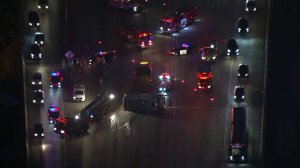 A vehicle appears on its side, blocking lanes on the southbound 110 Freeway, on Oct. 14, 2019. (Credit: Sky5)