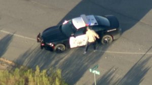 A man involved in a pursuit in the Antelope Valley jumps in a CHP vehicle on Oct. 2, 2019. (Credit: KTLA)