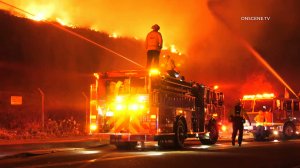Firefighters respond to a brush fire burning near homes in Fullerton on Oct. 30, 2019. (Credit: OnScene.TV)