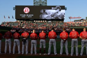 The Los Angeles Angels of Anaheim stand for a moment of silence before they play the Seattle Mariners at Angel Stadium of Anaheim on July 12, 2019 in Anaheim. (Credit: John McCoy/Getty Images)