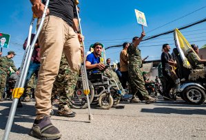 Fighters and veterans from the Kurdish women's protection units (YPJ) and the people's protection units (YPG) march in front of the United Nations headquarters in the northern Kurdish Syrian city of Qamishli during a protest against Turkish threats in the Kurdish region, on Oct. 8, 2019. (Credit: DELIL SOULEIMAN/AFP via Getty Images)