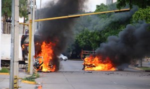 Vehicles burn in a street of Culiacan in Sinaloa state, Mexico, on Oct. 17, 2019.(Credit: STR / AFP via Getty Images)