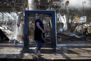 Stephanie Watson of Dallas walks in front of a damaged Talbot's store in Dallas on Oct. 21, 2019. (Credit: Ronald Martinez / Getty Images)