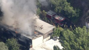 Firefighters respond to a blaze at a home in the Hollywood Hills on Oct. 4, 2019. (Credit: KTLA)