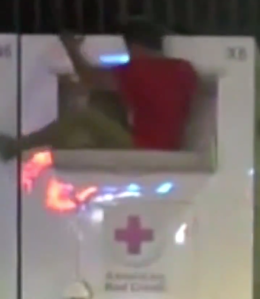 A flexible theft suspect was caught on camera climbing into a Red Cross donation box in Norwalk on Oct. 17, 2019. (Credit: Los Angeles County Sheriff's Department)