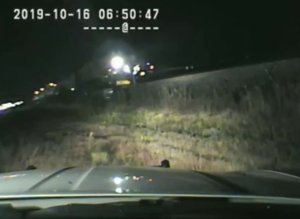 A still from dashcam footage released by the Utah Highway Patrol on Oct. 16, 2019, shows the moment earlier that same day when a trooper rescued a driver from a vehicle seconds before it was struck by an oncoming train.