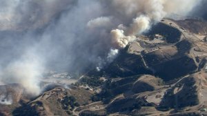 Smoke billows above the Saddleridge Fire in the area of SoCal Gas' Aliso Canyon facility on Oct. 11, 2019. (Credit: KTLA)