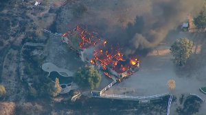 A large home in the Canyon Country area burns during the Tick Fire on Oct. 24, 2019. (Credit: KTLA)