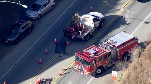 Rescuers work at the scene of a collision involving public works employees in the Santa Monica Mountains near Agoura Hills on Oct. 3, 2019. (Credit: KTLA)