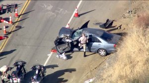 Rescuers work at the scene of a collision involving public works employees in the Santa Monica Mountains near Agoura Hills on Oct. 3, 2019. (Credit: KTLA)