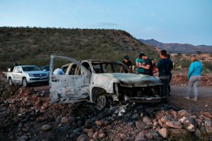 Members of the Lebaron family mourn as they look at the burned car where part of the nine murdered members of their family were killed and burned during an ambush in Bavispe, Sonora mountains, Mexico, on Nov.5, 2019. (Credit: HERIKA MARTINEZ/AFP via Getty Images)