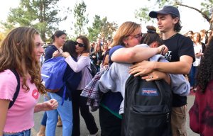 Grieving students from Saugus High School reunite with their parents at Central Park in Santa Clarita after a fatal school shooting on Nov. 14, 2019. (Credit: Frederic J. Brown / AFP / Getty Images)