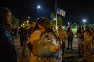 Mourners hug at a vigil held for shooting victims on Nov. 17, 2019 in Santa Clarita. (Credit: Apu Gomes/Getty Images)