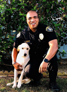 San Diego police Officer Andre Thomas poses with Victor in a photo released by city officials on Nov. 16, 2019. 