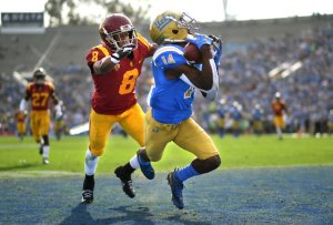 UCLA receiver Theo Howard catches a touchdown pass in front of USC defensive back Iman Marshall during the first quarter at the Rose Bowl on Nov. 17, 2018.