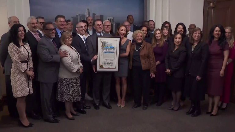Don Corsini is surrounded by family, KTLA staff and City Council members on Dec. 11, 2019, "Don E. Corsini Day" in the city of Los Angeles. (Credit: KTLA)