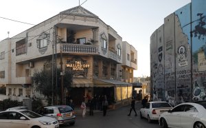A new Christmas-themed artwork dubbed the "Scar of Bethlehem" by secretive British artist Banksy is displayed at his Walled-Off Hotel in Bethlehem in the occupied West Bank on Dec. 20, 2019. (Credit: AHMAD GHARABLI / AFP) (Photo by AHMAD GHARABLI/AFP via Getty Images)