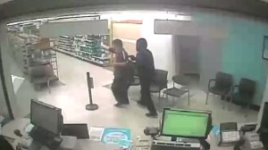 Surveillance video released by police shows a man armed with a gun robbing a Walgreens in Garden Grove on Dec. 13, 2019.