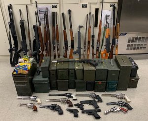 Police seized 33 guns and half a pound of methamphetamine, as well as arrested to convicted felons, during a probation search in Riverside County on Dec. 12, 2019. (Credit: Riverside Police Department)