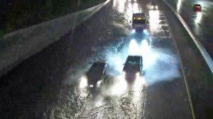 Drivers try to avoid a flooded portion of the 5 Freeway near the 110 Freeway on Dec. 23, 2019. (Credit: KTLA)