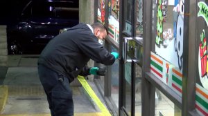 Investigators are seen at a 7-Eleven store in Northridge following an armed robbery on Dec. 20, 2019. (Credit: RMG News)