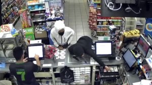 Surveillance video shows two men rob a 7-Eleven in Northridge at gunpoint on Dec. 20, 2019.