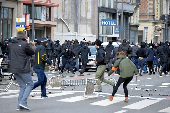 Right-wing demonstrators disrupt a peaceful gathering on March 27, 2016 in Brussels, Belgium. People gathered at the Place de la Bourse to pay tribute at a makeshift memorial for victims of deadly attacks in Brussels. (Photo by Dursun Aydemir/Anadolu Agency/Getty Images)