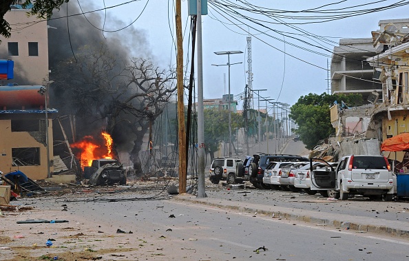 Fire is seen at the scene of a car bomb attack claimed by Al-Qaeda-affiliated Shabaab militants which killed at least 5 people, on the Naasa Hablood hotel in Mogadishu on June 25, 2016. The hotel in southern Mogadishu is often used by politicians and members of the Somali diaspora visiting the city. The attack came just three weeks after another assault quickly claimed by the Al-Qaeda-linked Shabaab group on the city's Ambassador hotel left 10 dead including two lawmakers when a huge car bomb ripped the front off the six-storey building. / AFP / MOHAMED ABDIWAHAB (MOHAMED ABDIWAHAB/AFP/Getty Images)