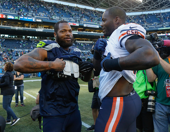 Defensive end Michael Bennett #72 (L) of the Seattle Seahawks is greeted by his younger brother Martellus Bennett #83 of the Chicago Bears after the game at CenturyLink Field on September 27, 2015 in Seattle, Washington. (Photo by Otto Greule Jr/Getty Images) *** Local Caption *** Michael Bennett;Martellus Bennett