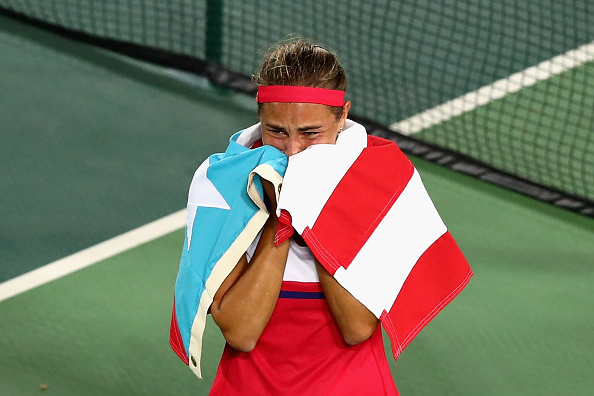 Monica Puig of Puerto Rico reacts after defeating Angelique Kerber of Germany in the Women's Singles Gold Medal Match on Day 8 of the Rio 2016 Olympic Games at the Olympic Tennis Centre on August 13, 2016 in Rio de Janeiro, Brazil. Puig defeated Kerber 6-4, 4-6, 6-1. (Photo by Dean Mouhtaropoulos/Getty Images)
