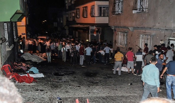 Bodies are covered as people gather at the explosion site on August 20, 2016 in Gaziantep, in a late night militant attack on a wedding party in southeastern Turkey. The governor of Gaziantep said 22 people are dead and 94 injured in the late night militant attack. (STR/AFP/Getty Images)