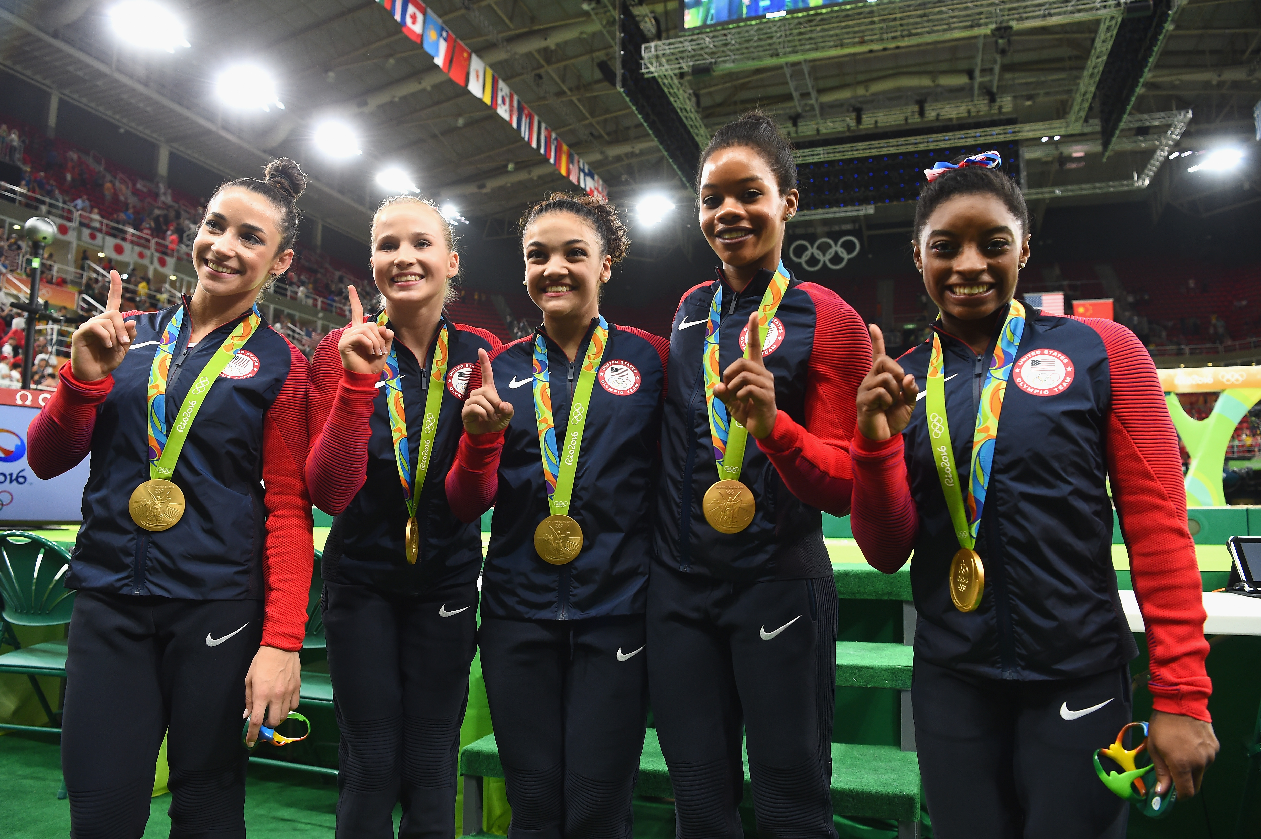 RIO DE JANEIRO, BRAZIL - AUGUST 09: (L to R) Gold medalists Alexandra Raisman, Madison Kocian, Lauren Hernandez, Gabrielle Douglas and Simone Biles of the United States pose for photographs with their medals after the medal ceremony for the Artistic Gymnastics Women's Team on Day 4 of the Rio 2016 Olympic Games at the Rio Olympic Arena on August 9, 2016 in Rio de Janeiro, Brazil. (Photo by Laurence Griffiths/Getty Images)