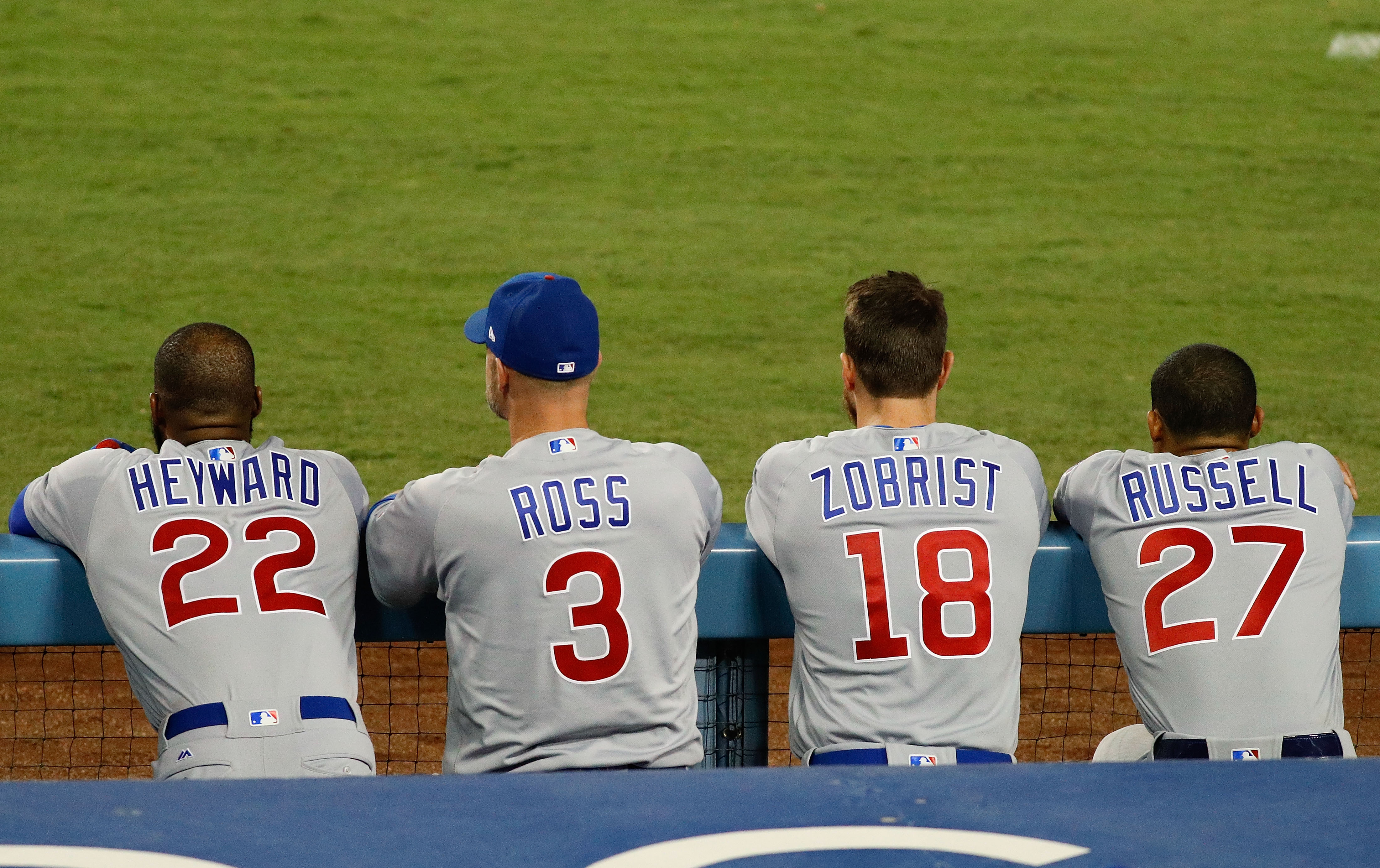 LOS ANGELES, CA - OCTOBER 19: Jason Heyward #22, David Ross #3, Ben Zobrist #18, and Addison Russell #27 of the Chicago Cubs look on from the dugout against the Los Angeles Dodgers in game four of the National League Championship Series at Dodger Stadium on October 19, 2016 in Los Angeles, California. (Photo by Josh Lefkowitz/Getty Images)